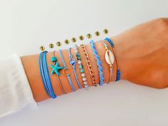 "Unique style bracelets for the summer. Beautiful stack of bracelets , in blue/gray colors, perfect like set or to combine with your other jewelry. Easy going for every day wearing. An assortment of adjustable closure bracelets, designed to fit all sizes. In bright light colors, with details in gold color. Each bracelet is beautiful on is one, and together tey make great set. Take full set, and have fun with mix and match all summer. You can choose the whole set of 9 bracelets or take each one s Casual Summer Wrap Bracelet As Gift, Blue Braided Bracelets As Summer Gift, Blue Braided Bracelets For Summer Gift, Blue Braided Bracelet Gift For Summer, Resizable Friendship Bracelet For Beach, Summer Gift Resizable Bracelets, Adjustable Trendy Charm Bracelet For Summer, Trendy Adjustable Charm Bracelet For Summer, Blue Bracelets As Summer Gift