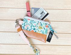 This mini pouch measures 5 by 4 inches. It comes with a coordinating wristlet/key fob. Alligator clasp is sturdy, but makes it easy to hook on keys and other necessities.  Pouch has a faux leather bottom and is lined with coordinating cotton fabric.  Mini pouches are perfect for holding your essentials. Change, cash, credit cards, AirPods, and a chapstick.  Don't see what you're looking for? Send me a message and we can create a custom pick you'll love! Please note, fabric design placement may differ than pictured. Adjustable Wristlet With Interior Key Chain Holder For Travel, Rectangular Coin Purse With Key Leash, Adjustable Wristlet With Cell Phone Pocket For Everyday Use, Adjustable Wristlet With Card Slots For Everyday Use, Daily Use Wristlet With Key Leash, Everyday Use Rectangular Wristlet With Key Clip, Everyday Rectangular Wristlet With Key Clip, Rectangular Wristlet With Key Clip For Everyday, Adjustable Wristlet With Removable Pouch