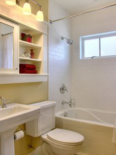 a bathroom with a sink, toilet and bathtub next to a window in it