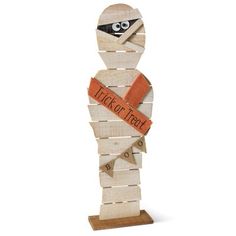 a wooden sculpture with an orange ribbon around it's neck and the words trick or treat on it