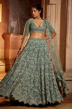 Sage green tulle lehenga with attached cancan, heavily embroidered in a floral pattern with tonal beads, sequins, crystals with some rose highlights. Paired with embroidered padded blouse and scallop dupatta.
Component: 3
Pattern: Embroidered
Type Of Work: Floral
Neckline: Plunge V Neck
Sleeve Type: Tassel
Fabric: Tulle
Color: Green
Other Details: 
Back tie-up
Embroidered dupatta
Tassel blouse
Occasion: Bride,Wedding - Aza Fashions Rose Highlights, Tulle Lehenga, Scallop Dupatta, Green Lehenga Choli, Gold Tulle, Tassel Blouse, Green Tulle, Bridal Lehenga Red, Green Lehenga