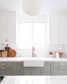 an instagram page with white and grey kitchen cabinets