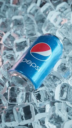 a pepsi soda can sitting on top of ice