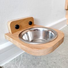 a wooden sink mounted to the side of a wall