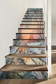 an artistic stair case painted with trees and snow