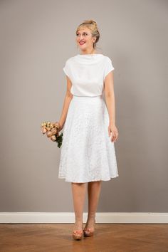 "Our bridal top Aennie is a simple, elegant top made of extremely delicate viscose fabric, with trimmed sleeves and a flowing neckline. Made of extremely delicate creamy white viscose fabric. With our Aurelie, Valerie or Livia bridal skirts, Aennnie is a wonderful top for the registry office or your summer wedding. Size / dimensions / weight \"Naomi\" is available in sizes 36-42. For other sizes, please just ask! used material 100% viscose Care instructions: machine washable at 30 degrees, iron Chic Short Sleeve Lace Top For Wedding, Elegant White Viscose Top, Elegant Flowy Viscose Blouse, Chic Off-white Wedding Tops, Chic Off-white Tops For Wedding, Chic Off White Tops For Wedding, Elegant Off White Lace Top, Fitted White Viscose Top, White Fitted Viscose Top