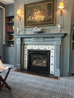 a living room filled with furniture and a fire place under a painting on the wall