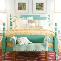 a bedroom with yellow and green decor on the walls, blue bedding and white pillows