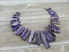 "Rare Charoite Statement Necklace.  Rough cut stick beads are lightly polished.  One of a kind! Charoite is a rare stone, which comes only from the Charo River region in Siberia. The Charoite sticks are nicely polished and range from  15- 55 mm ( 5/8 to 2 1/4\")  They are separated by bright sterling silver plated beads.   Chain, Toggle Clasp, and findings are Silver plated brass.  They are nickel and lead free. SALES TAXES: CANADA: All of our prices include GST/HST for Canadian customers.  This includes the shipping charges.   PST will be added where required by law. USA / INTERNATIONAL: The prices shown do not include Canadian Sales taxes.  Taxes collected by your country will be added to your total by Etsy where required by law. RETURNS:   Returns are permitted on some products.  Please Charoite Necklace, Purple Jasper, Luxe Jewelry, Necklace Purple, Rare Stone, Bib Necklaces, Purple Stones, Rough Cut, Name Necklace