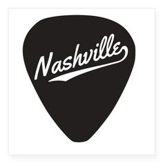 a person holding up a guitar pick with the word nashville on it