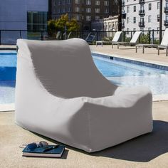 an inflatable chair next to a swimming pool