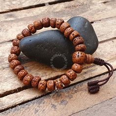 Introducing our exquisite Natural Aged Brown 5 Mukhi Rudraksha Buddhist Bracelet, a harmonious fusion of spiritual significance and timeless elegance. Handcrafted with care, each Rudraksha bead is meticulously sanded in a tumbler, ensuring unparalleled comfort against your skin. The beads are then naturally stained and delicately oiled, revealing a stunning and rich brown hue that accentuates the inherent beauty of these sacred seeds. Our artisans skillfully incorporate an adjustable knot into the design, allowing you to personalize the fit for optimal comfort. The bracelet not only serves as a meaningful accessory but also carries the essence of tradition and mindfulness. 📏Beads Size : 8-8.5 MM  📏Bracelet length: 7.0-7.25 Inches - Adjustable to 2.0 inches The 5 Mukhi Rudraksha beads hol Adjustable Bracelets For Meditation And Festivals, Adjustable Spiritual Bracelets For Festivals, Adjustable Traditional Bracelets For Rituals, Adjustable Spiritual Bracelets For Rituals, Adjustable Brown Bracelet For Festivals, Adjustable Brown Bracelets For Festivals, Traditional Adjustable Bracelet With 8mm Beads, Bohemian Bangle Bracelet For Puja, Traditional Hand-wrapped Bracelets For Meditation