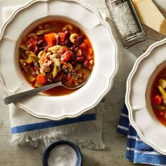 two bowls of soup on top of a table