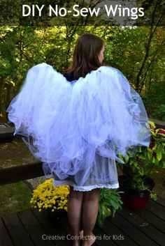 a girl wearing a white tutu skirt with the words diy no sew wings