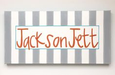 a striped canvas with the word jacksonville painted in orange and blue, on a white wall