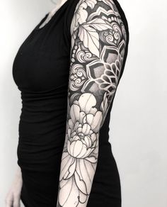 a woman with a black and white tattoo on her arm