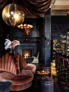 a fancy bar with lots of chairs and tables next to a fire place in the fireplace