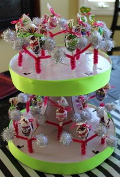 three tiered christmas tree made out of candy canes and tinsel on top of each other