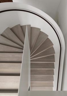 a spiral staircase in a home with white walls