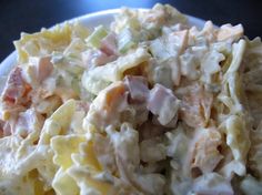 a bowl filled with pasta salad on top of a table