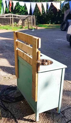 a wooden box sitting on the side of a road