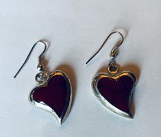 "This is a pair of heart-shaped sterling silver (.925) red dangle/drop earrings. Material(s): Sterling Silver (.925) + red stone (the photos make the heart appear black, but they are a dark red) Total weight: 6.2 grams Flaws (if any): None to mention Marking(s): \".925\" (translating to \"sterling silver\") Measurements: The drop length of these earrings is 1 and 3/8 inches. The width of these earrings is 3/4 of an inch, at their widest point. If you have any questions about this pair of earring Red Sterling Silver Pierced Heart Earrings, Red Sterling Silver Dangle Heart Earrings, Handmade Red Heart Earrings In Sterling Silver, Handmade Red Heart Sterling Silver Earrings, Vintage Red Heart Earrings For Gift, Red Vintage Heart Earrings For Gifting, Vintage Red Heart Earrings As Gift, Red Vintage Heart Earrings For Gift, Red Stone