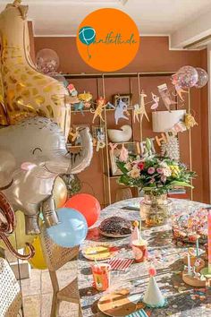 a room filled with lots of balloons and decorations