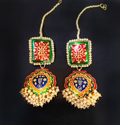 red Green Navy Meena Pearl EARRINGS If you like to make a statement with your jewelry then this is the piece to own Elongated Gold plated Traditional Kundan Earrings **Made in pure .925 sterling silver base and 18 K Gold plated. **Paisley style chandelier earrings, hand enameled with real pearls along the edges with elegant royal hand painted motif an elegant fusion design. **Fresh Water Pearls on the bottom **Length- 3.25 inches and width - 1.2 inch at the widest point These earrings will be sh Multicolor Tilla Jewelry For Gifts, Traditional Green Jewelry For Gift, Elegant Ceremonial Earrings With Motifs, Gold Plated Green Jewelry With Latkans, Green Gold-plated Jewelry With Latkans, Jewelry With Motifs For Diwali Gift, Handmade Multicolor Bridal Earrings, Traditional Green Jewelry With Motifs, Diwali Jewelry With Motifs As Gift