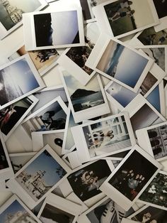 many polaroid pictures are arranged together on the wall