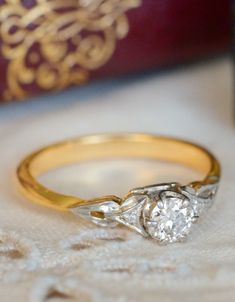 an engagement ring sitting on top of a table