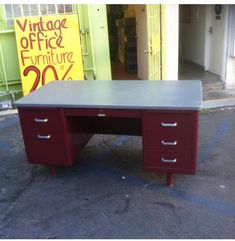 an office desk sitting in the middle of a parking lot