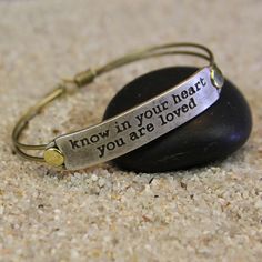 The message behind Know in your heart you are loved The most profound happiness in life is the knowledge that you are loved. It is the greatest treasure, the most mysterious and magical joy and a radiance that never fades.åÊ Knowing you are loved motivates you to be worthy of the love you receive. Choice of bangle, black leather, brown leather and wine leather. Arrives in a black suede pouch with lifetime warranty card.åÊåÊ Bangle and leather bracelets measure 7" around. If you require a differe Meaningful Adjustable Bangle Bracelet, Meaningful Friendship Bangle Bracelets, Inspirational Hypoallergenic Bracelet For Friendship, Spiritual Adjustable Hand Stamped Bracelets, Adjustable Spiritual Hand Stamped Bracelets, Meaningful Faith-inspired Bracelet Jewelry, Inspirational Adjustable Hand Stamped Jewelry, Personalized Inspirational Friendship Bracelets, Inspirational Personalized Friendship Bracelets