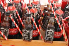 coca - cola bottles with red and white striped paper straws in front of them