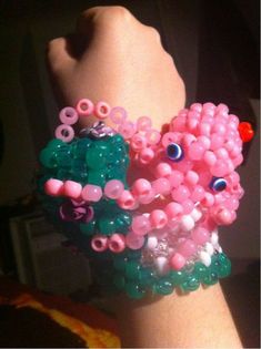 an octopus bracelet is made out of beads and other things that are attached to someone's wrist