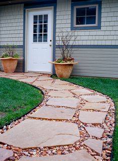 a stone path in front of a house