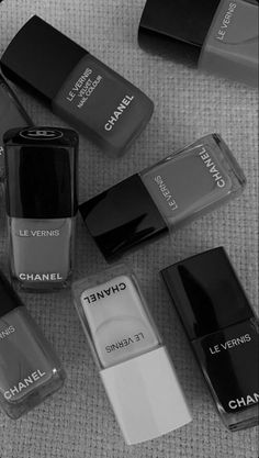 several chanel nail polishes are laying on the floor