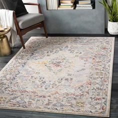 an area rug in a living room with a chair and bookshelf behind it