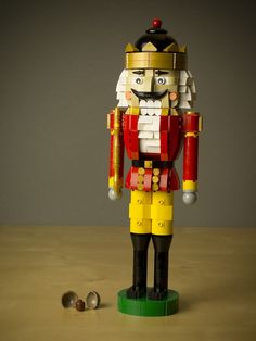 a toy nutcracker is standing next to some nuts