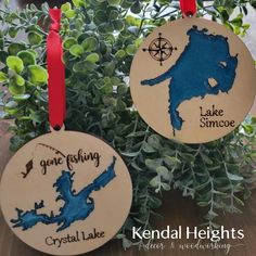 two wooden ornament shaped like the state of lake george and crystal lake are shown