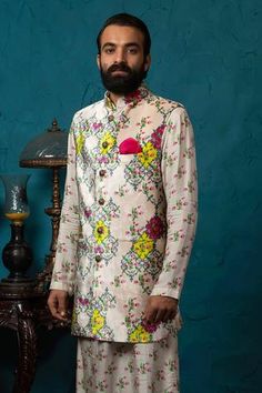 Blush bundi with floral printed motifs and front button placket. Paired with floral printed kurta and churidar.
Component: 3
Printed
Neckline: Band
Sleeve Length: Full
Fabric: Velvet, Silk
Color: Peach,Beige
Note: Pocket square worn by the model is not for sale - Aza Fashions Silk Kurta Set, Kurta Set For Men, Fancy Kurti, Silk Kurta, Nehru Jackets, Churidar, Kurta Set, Pocket Square, Floral Printed