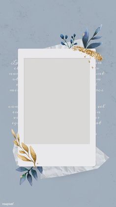 an empty photo frame surrounded by leaves and paper on a blue background with gold foil