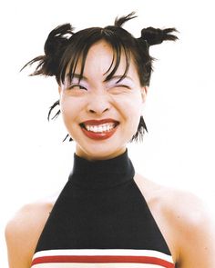 a woman with her hair in pigtails smiling