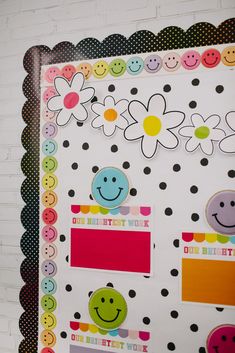 a colorful bulletin board with smiley faces and flowers on the front, along with polka dots