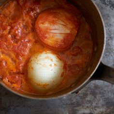 two eggs are being cooked in a saucepan