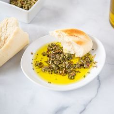 a white plate topped with bread and olive oil