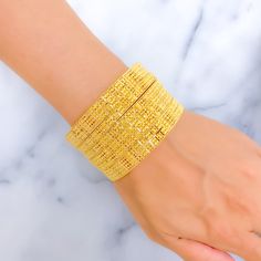 Indulge in luxury with our Royal Floral Checkered 22K Gold Bangle Set. Crafted in 22k gold, this exquisite set features a total weight of 92.5g, radiating opulence. The captivating floral checkered design and lustrous yellow gold finish make it a statement of high fashion. Bangle Size 2.7 with a 2.45" diameter opening. Set includes 6 stunning bangles PRODUCT DETAILS Gold Purity(karat): 22k Gold Weight(grams): 92.5 Item Finish: Yellow Gold Bangle Size: 2.7 Bangle Opening(diameter): 2.45" Number O Festive Yellow Bangle Jewelry, Yellow Gold Jubilee Bangle Bracelet, Festive Yellow Bangle Bracelet, Yellow Gold-plated Bracelets For Wedding, Yellow Gold Plated Bracelets For Wedding, Hand-set Yellow Gold Bracelets For Diwali, Hand Set Yellow Gold Bracelet For Diwali, Yellow Gold-plated Bangle Bracelet, Luxury Hand-set Gold Bangle