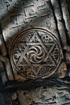 an image of some kind of stone with writing on it's sides and symbols in the middle