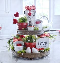 two tiered trays with red and white dishes on top of each other in a kitchen decorated for valentine's day