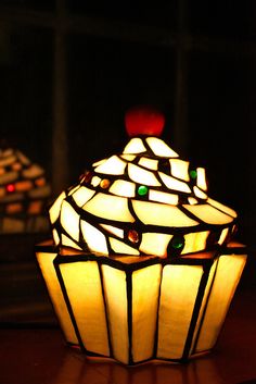 a stained glass lamp sitting on top of a wooden table