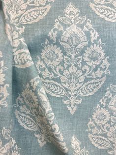 a blue and white fabric with an ornate design